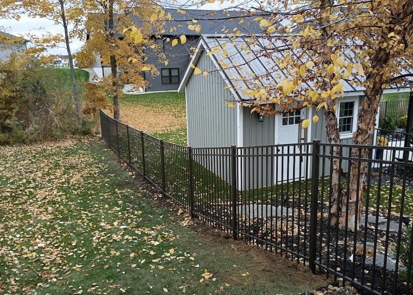 Black ornamental aluminum fence around a residential property